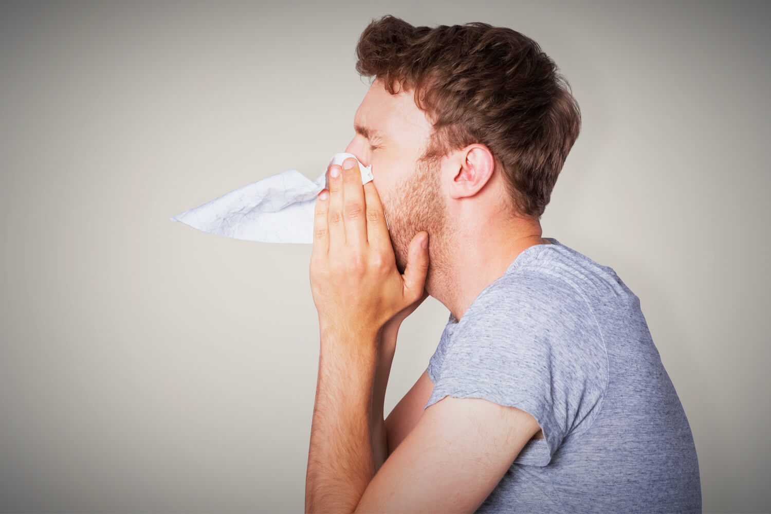 man-blowing-nose